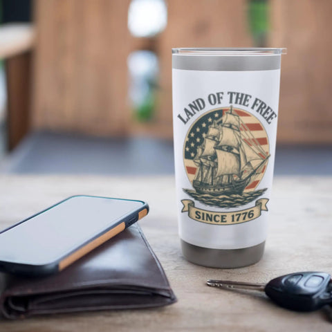 Patriotic American Flag Sailboat Insulated Tumbler Stainless Steel Travel Cup on desk with ship design and text 'Land of the Free'