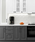 Modern kitchen with 30 Pack 5 Inch Center Black Matte Cabinet Pulls Arch Style Drawer Handles on gray and white cabinets.