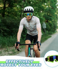 Cyclist wearing OTG Ski Goggles For Over Glasses With Anti Fog Lenses, Colorful Lenses And Fluorescent Frames, on a road.