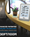 Wireless Indoor Outdoor Thermometer With 4.5 Inch Backlit Display Digital Hygrometer And Temperature Humidity Monitor Seriously Accurate Sensor With 330 Ft Range for indoor and outdoor readings displayed on a stand.