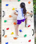 Girl climbing on wooden wall with Four Pack Solid Safety Playground Handles Featuring Glow Grip Tech Heavy Duty Anti Slip Handholds.