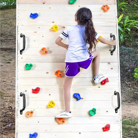 Girl climbing on wooden wall with Four Pack Solid Safety Playground Handles Featuring Glow Grip Tech Heavy Duty Anti Slip Handholds.