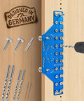 Close-up of 2 In 1 11-Hole Shelf Pin Jig And Concealed Hinge Drilling Guide with bits, mounted on plywood