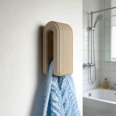 Premium Wall Mount Automatic Locking Towel Hook With Smart Space Saving Design And No Sweat Storage For Daily Grind In Slick Matte Black Finish For Any Modern Setup holding a blue towel.