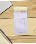 Carbon Copy Receipt Book For Small Biz 3 Part Invoice Pad With Simple Design And Clear Legibility Lightweight Order Receipt Book For Customer Transactions Fast Doc Speed And Error Reduction. delivery note pad on wood desk