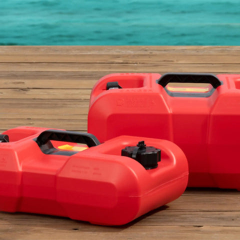 Two red 3-Gallon Portable Boat Gas Tanks With Built-In Fuel Gauge, 2-Way Vented Cap, Top Handle, Underseat Design on wooden dock.