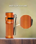 Close-up of Baton4 Rechargeable EDC Flashlight With 1300 Lumens showing anti-slip texture, bright orange body.