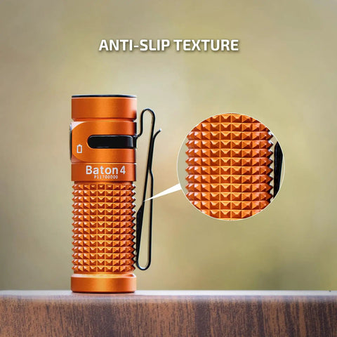 Close-up of Baton4 Rechargeable EDC Flashlight With 1300 Lumens showing anti-slip texture, bright orange body.