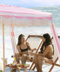 Boho Beach Cabana With Fringe And Tassels, 7x7 Ft Easy Setup Canopy with pink rose stripes, wood poles, at sunny beach setting