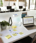 Office desk with a laptop and notes featuring Canary Yellow Sticky Notes 3x3 Inch Set, 18 Pads With 100 Sheets Each, 1,800 Total Sheets.