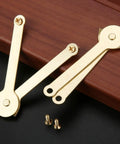 Gold Metal Lid Support Hinges Set Heavy Duty 2.68 by 0.31 Inch 2 Pack shown on wooden surface with screws