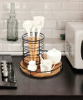 12 Inch Acacia Wood Lazy Susan Turntable with Steel Sides on kitchen counter holding utensils and condiments.