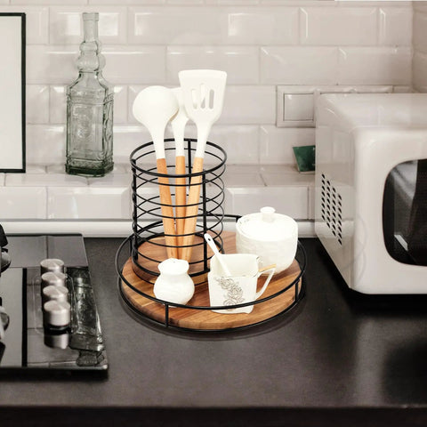 12 Inch Acacia Wood Lazy Susan Turntable with Steel Sides on kitchen counter holding utensils and condiments.