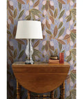 Top Shelf Hand Drawn Botanical Vinyl Wallpaper Featuring Subtle Leather Texture in a living room with lamp and wooden table.
