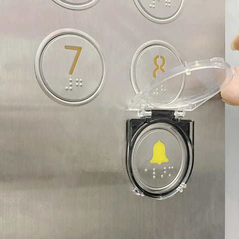 Dustproof Safety Push Button Cover Protector For PCs Computers Dishwashers And Washing Machines With Easy Install Double Sided Tape Keeps Dirt Out And Buttons Safe No Fuss Elevator Button Shield shown installed over elevator button.