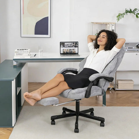 Woman reclining on grey Massage Office Chair With Foot Rest And Heat High Back Six Vibration Points For Ultra Comfy Recline Executive Desk Chair Big And Tall Office Chair Up To 400lbs Ergonomic Managerial Chair Grey in home office setting.