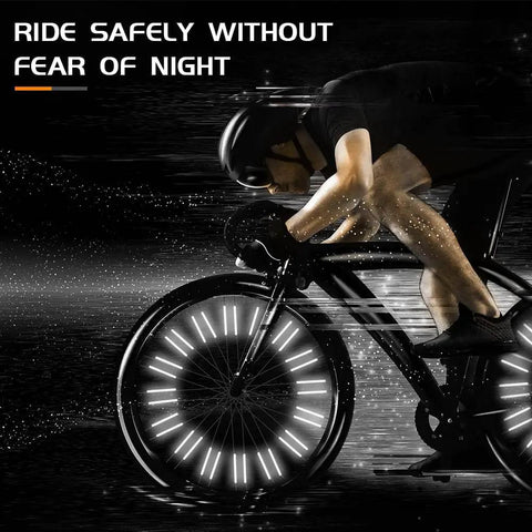 Cyclist riding at night with 48 Pcs 360 Degree Visibility Bike Spoke Reflectors Waterproof Reflective Clips for safety.