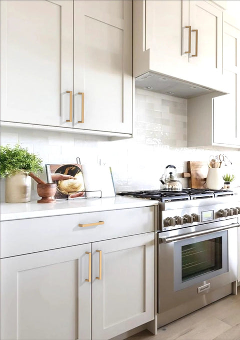 Kitchen with Champagne Bronze Cabinet Pulls 5 Inch 128mm Solid Zinc Alloy Handles installed on white cabinets and drawers.
