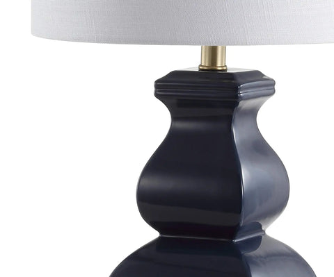 Close-up of modern footed vase base of navy blue and gold ceramic table lamp with white linen shade, LED bulb included, UL listed.
