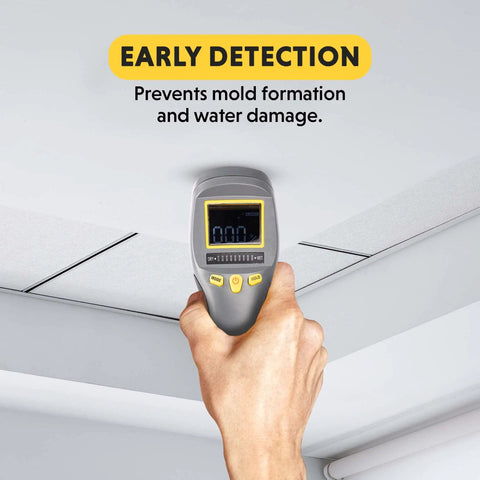 Hand using Pinless Moisture Meter With LCD Display For Wood And Construction Materials on ceiling for early moisture detection.