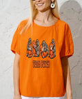 Woman wearing an orange t-shirt with Team Punch text and cartoon gorillas on the front
