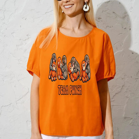 Woman wearing an orange t-shirt with Team Punch text and cartoon gorillas on the front