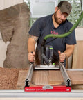 Man using Beefy Extended Slab Flattening Mill For Big Wood Slabs With 38.75 By 128.5 Inch Or 62.75 By 104.5 Inch Capacity Includes 72 Inch Rails 120 Inch Reach Router Sled Clamping Dogs USA Made Leveling Jig on large wood slab