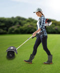 Gas Powered Handheld Sweeper Broom For Lawn Cleanup 52cc 2 Stroke Engine Two Point Three HP Portable Gasoline Powered Sweeping Machine With Fuel Tank Built To Last Durable ABS Aluminum Build Easy Start And Debris Removal, woman using it on lawn