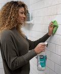 Woman using Tea Tree Bathroom Cleaner Spray For Glass And Tile, Foaming Mold And Mildew Remover For Tub And Shower, 32oz Pack Of 2 on tile