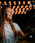 Person using Pocket Sized Pro Grade Bicolor Panel Mini LED Light For DSLRs With Adjustable Panel And LCD Display on camera
