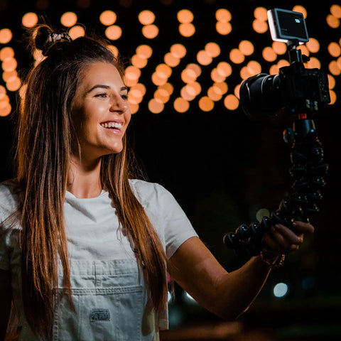 Person using Pocket Sized Pro Grade Bicolor Panel Mini LED Light For DSLRs With Adjustable Panel And LCD Display on camera