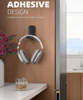 Sticky Headphone Holder Under Desk Clip Adhesive Headset Hanger Mount For AirPods Max HyperX Sennheiser Earphone Clamp No Drilling 500g Capacity Easy Install And Great Mothers Day Gift mounted on wall with headphones