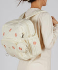 Woman wearing Diaper Bag Backpack For Moms Large Capacity Baby Travel Backpack With Changing Pad Insulated Bottle Pockets Medium Beige Floral