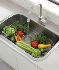 Heavy Duty Foldable Sink Protector Grid With Center Drain And Rounded Corners No Fuss Stainless Steel Drop In Sink Bottom Rack with fresh vegetables.