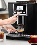 Person using Fully Automatic Coffee Machine With Built In Burr Grinder And Grind And Brew System One Tap Espresso Maker 1200W Power Auto Clean Function For Healthier Brews Black in kitchen setting.