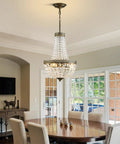 Elegant dining room featuring 4 Light French Empire Mini Crystal Chandelier With Antique Brass Finish over a wooden table.