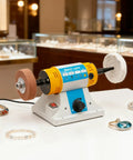 Industrial Strength Bench Buffer And Jewelry Polisher With Variable Speed Drive 320W Motor on a display table with jewelry pieces