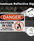 Rock Solid Oxygen In Use Safety Signs With No Smoking Warning 10X7 Inch Rust Free Aluminum Wall Placards 2 Pack on a fence.