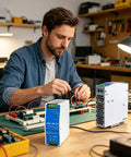 Man using Rock Solid 24 Volt Dc Din Rail Power Supply 120 Watt for PLC and CNC setups in workshop with components and tools.