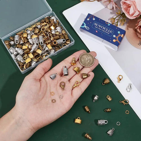 All-in-One Leather End Caps Kit for Jewelry Making, Kumihimo Bead Caps, Vintage Gold and Silver Tube Ends displayed on hand