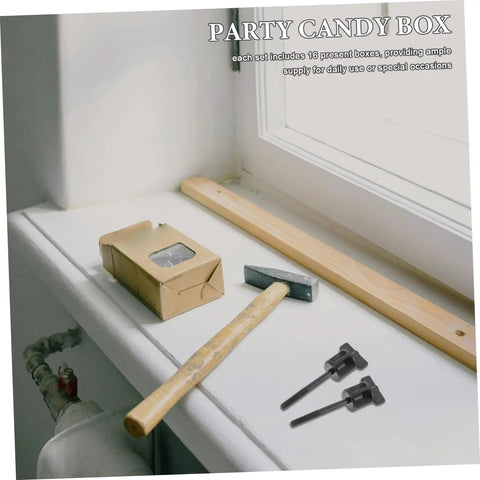 Hammer and anchor bolts next to cardboard box, unrelated to Universal Spare Tire Anchor Bolt Kit For Easy Install And Tight Fit