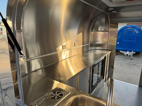 Interior view of Rock Solid Heavy Duty Mobile Coffee Concession Cart With Spacious Storage Compartments featuring stainless steel counters.