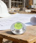 Small Horizontal Bubble Level on construction site with plans, featuring round design and high sensitivity bubble vial.