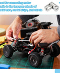 Person using rotatable universal steering shaft on model car for DIY projects and hobby builds with M4 screws visible