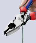 Hand using High Leverage Lineman Pliers Workhorse With Tape Puller And Crimper 09 12 240 SBA, cutting wire with serrated jaws.