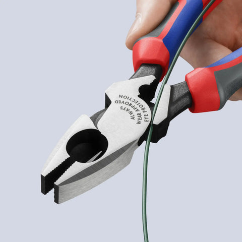 Hand using High Leverage Lineman Pliers Workhorse With Tape Puller And Crimper 09 12 240 SBA, cutting wire with serrated jaws.