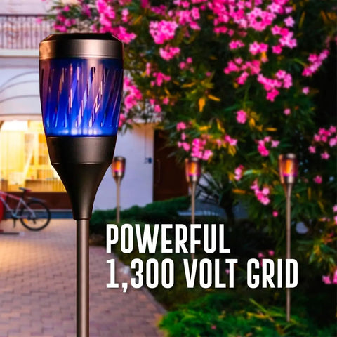 Solar Powered Tiki Torch Lantern Zapper with Realistic Flickering Flame in garden setting