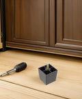 Set Of 6 Metal Furniture Legs With M8 Threaded Leveling Feet Dark Contemporary Square And Tapered Design Sturdy Wobble Free And Wear Resistant Upgrades Sofas Chairs Dressers Cabinets Keeps Your Home Looking Sharp black metal leg and leveling foot beside a wooden cabinet