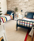 Bedroom with Vibe Ready Vinyl Wall Panels With Vintage Farmhouse Wood Pattern behind twin beds and books on a nightstand