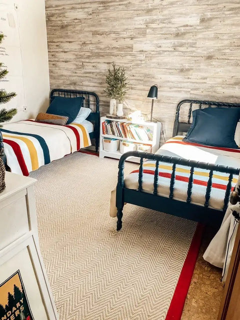 Bedroom with Vibe Ready Vinyl Wall Panels With Vintage Farmhouse Wood Pattern behind twin beds and books on a nightstand